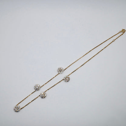 Lab diamond flower necklace with seven-stone clusters spaced along an 18K gold cable chain