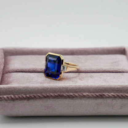 Lab Grown Emerald Cut Sapphire with Trapezoid Diamonds Gold Bezel Three Stone Ring, 18K Gold, view 6