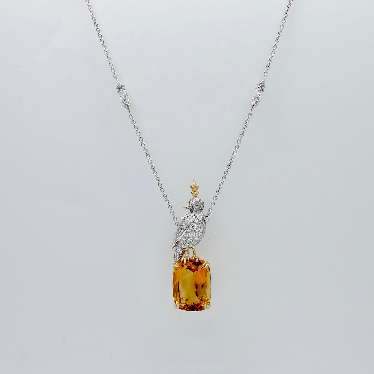 Platinum bird pendant pavé set with moissanites, perched on an 18 carat honey gold lab grown citrine