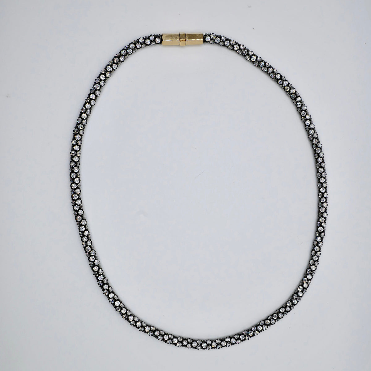 Pavé rope tennis necklace in oxidised sterling silver, set all the way around with moissanite or lab-grown diamonds, with an 18K yellow gold box clasp