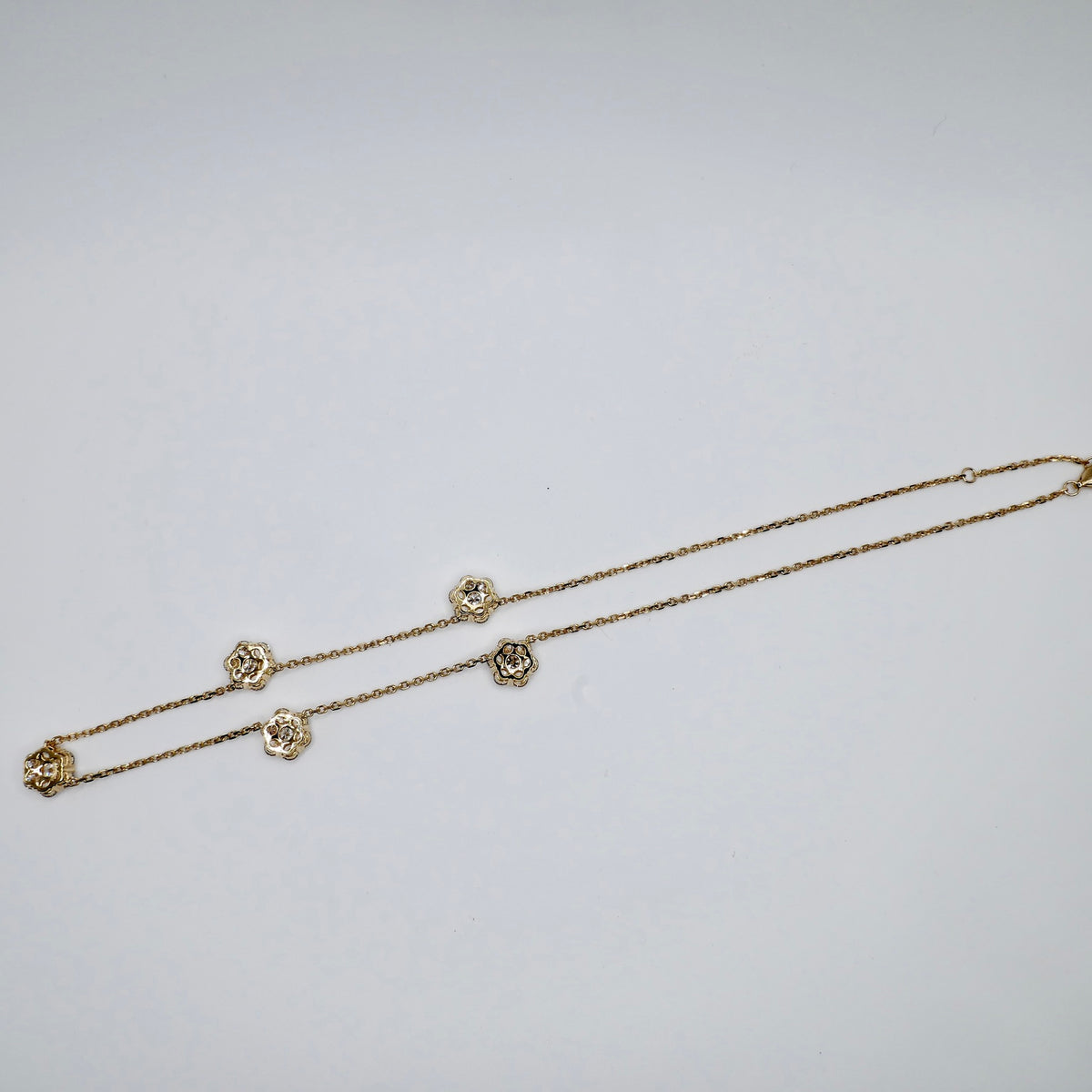 Back of the lab diamond flower necklace showing the 18K yellow gold flower settings and clasp