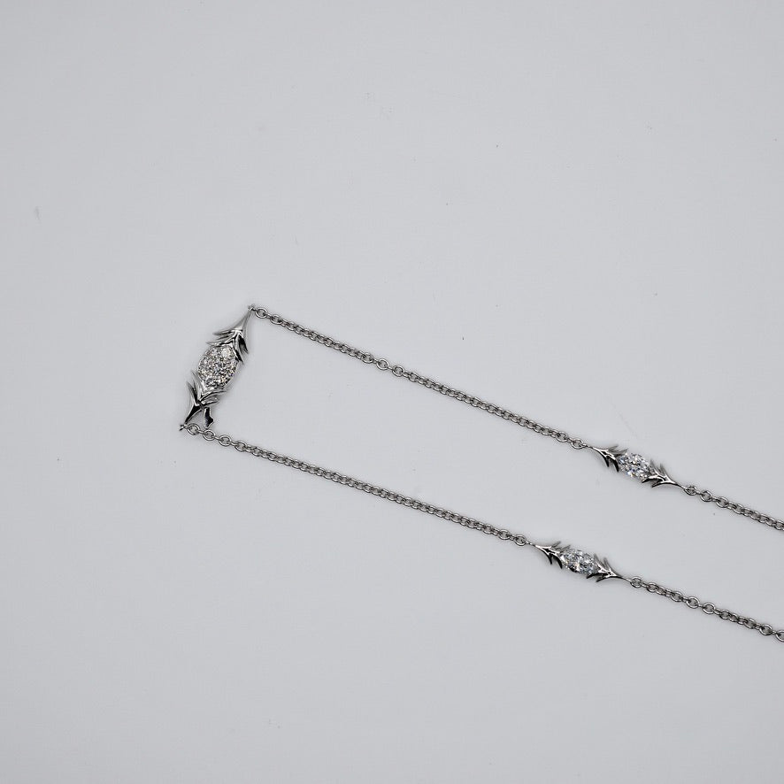 Handcrafted bird pendant necklace in solid 18K gold and platinum on a white gold chain