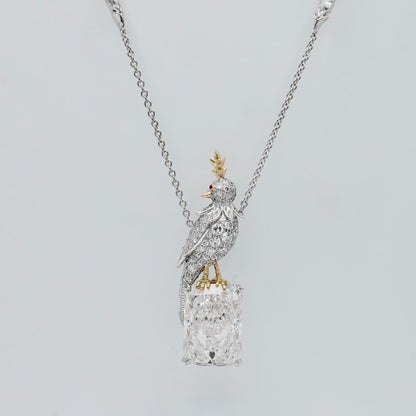 Bird necklace with an 18 carat radiant cut lab grown diamond and a pavé moissanite bird in platinum and 18K gold