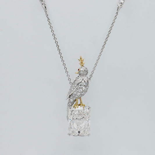 Bird necklace with an 18 carat radiant cut lab grown diamond and a pavé moissanite bird in platinum and 18K gold