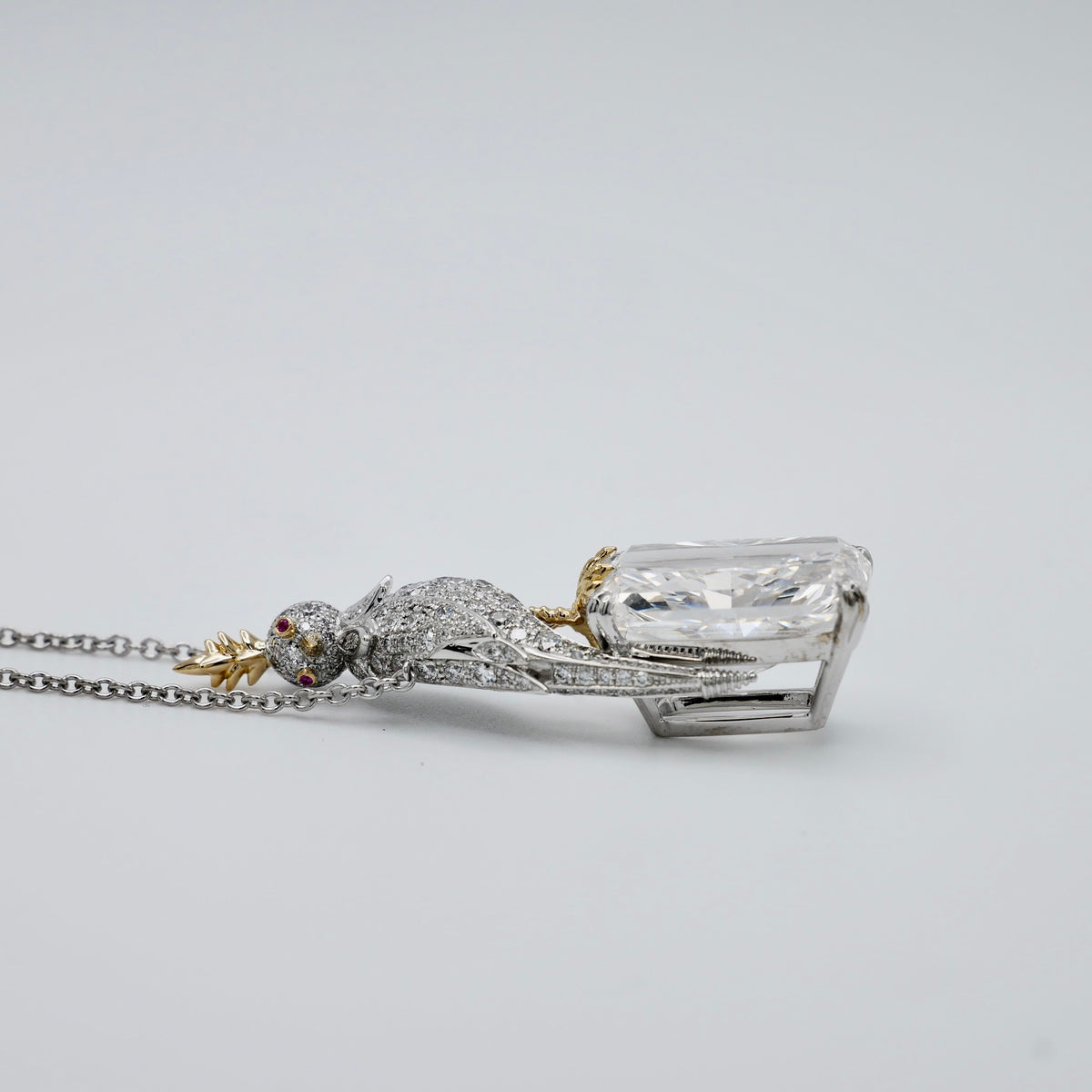 18 carat radiant cut lab grown diamond pendant with a gold crested bird in platinum and 18K gold