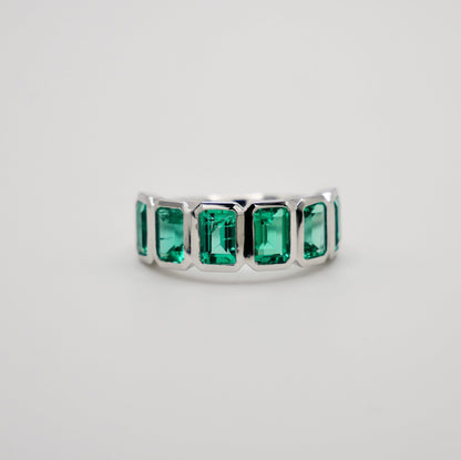 Half Eternity Lab Grown Emerald Cut Emerald Ring in Platinum Bezel Setting