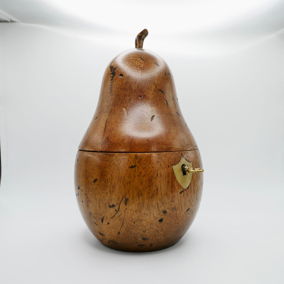 Georgian pear tea caddy in fruitwood showing the shield-form bone escutcheon and lock