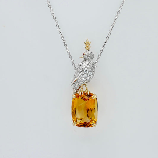 Bird necklace with an 18 carat cushion cut lab grown citrine and a pavé moissanite bird in platinum and 18K gold