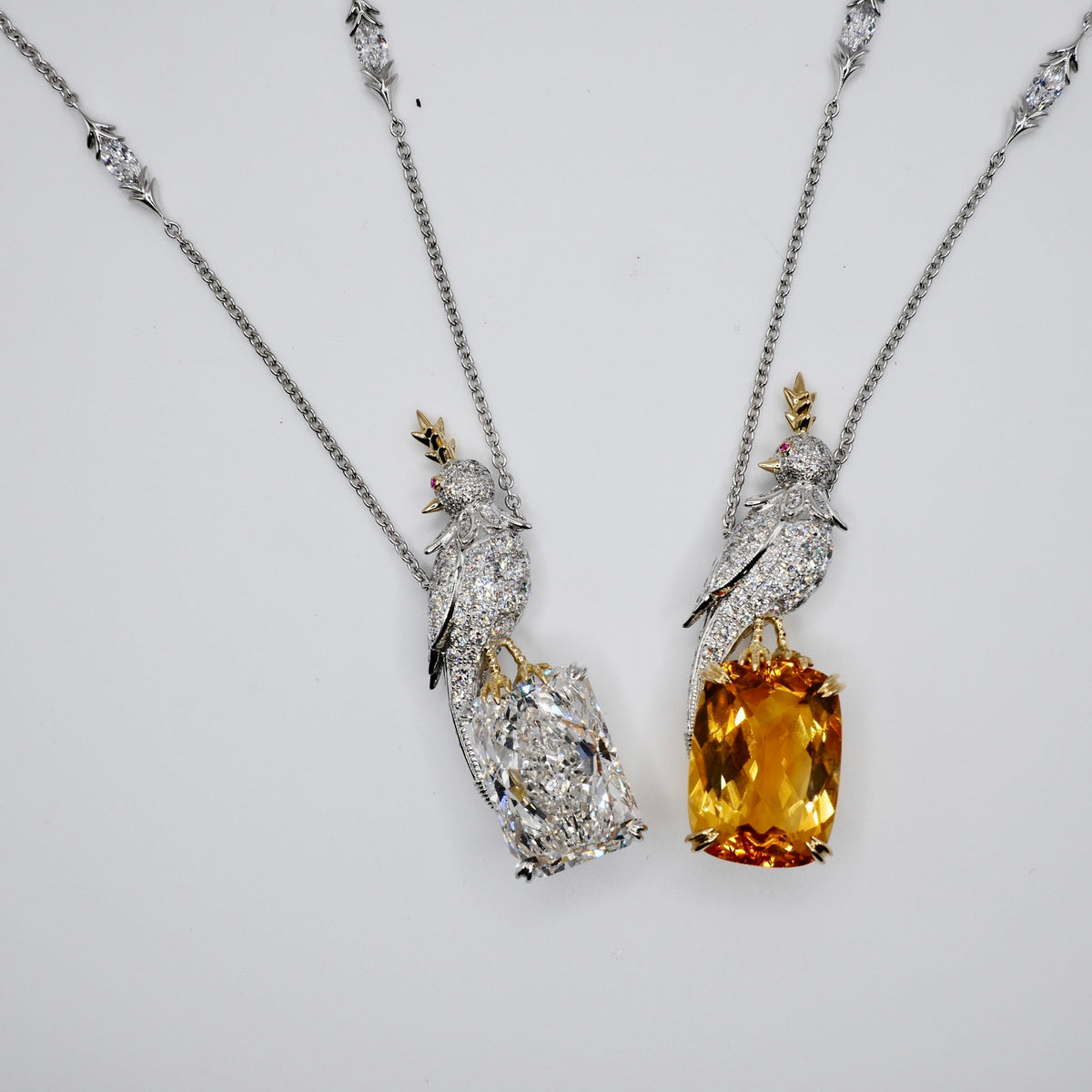 Platinum bird pendant with pavé moissanites and a polished 18K gold beak, made to order