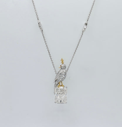 Platinum bird pendant pavé set with moissanites, perched on an 18 carat radiant cut lab grown diamond