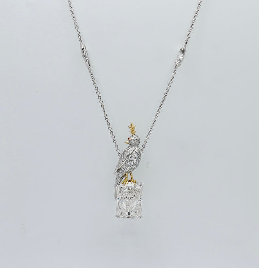 Platinum bird pendant pavé set with moissanites, perched on an 18 carat radiant cut lab grown diamond