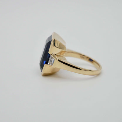 Lab Grown Emerald Cut Sapphire with Trapezoid Diamonds Gold Bezel Three Stone Ring, 18K Gold, view 4