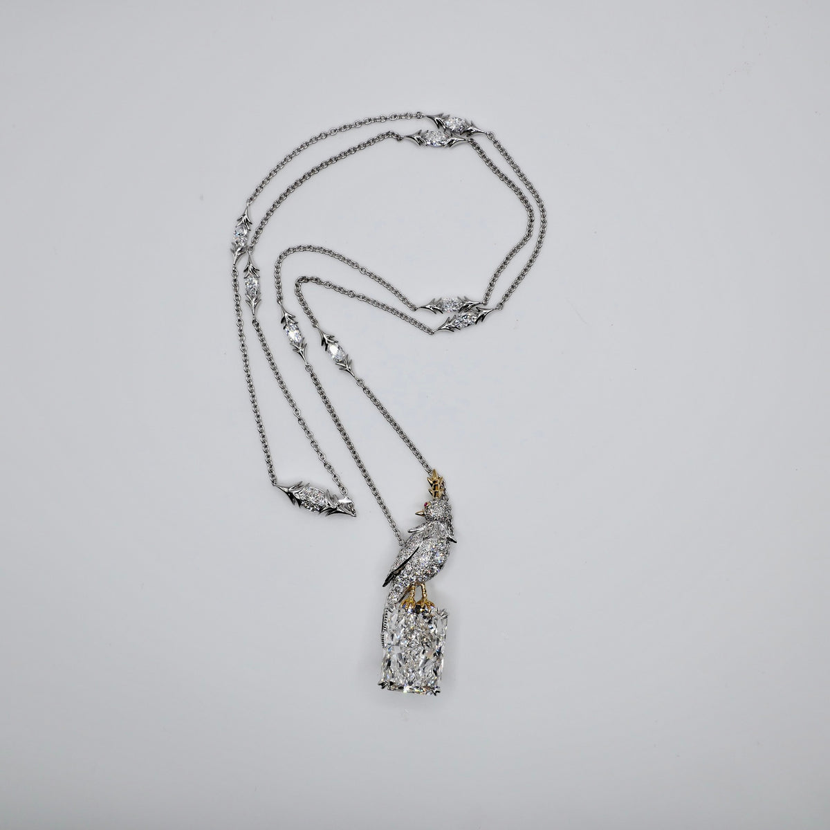18K solid gold and platinum bird necklace with an 18 carat radiant cut lab diamond