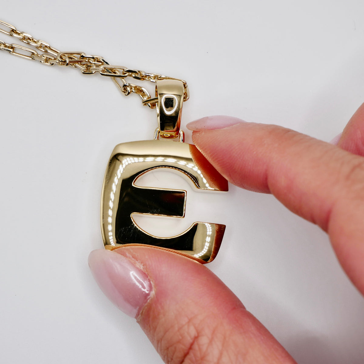 Solid gold bubble letter initial pendant with pierced counter and rounded block form
